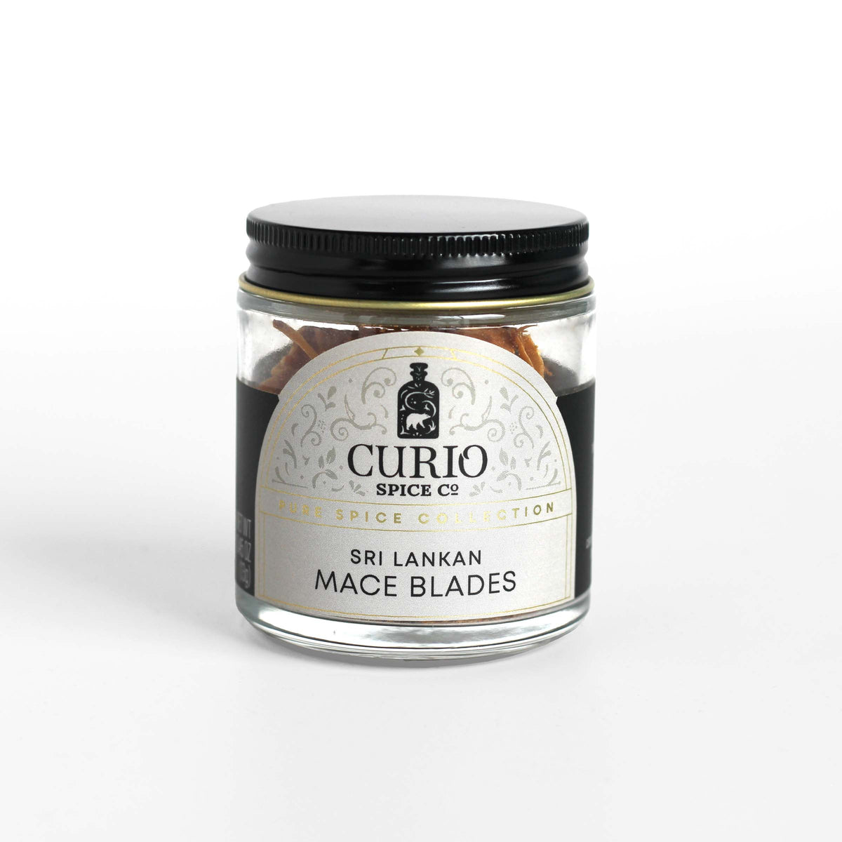 Curio Spice Co. fair-trade single origin sustainable Sri Lankan mace blades in a glass jar.