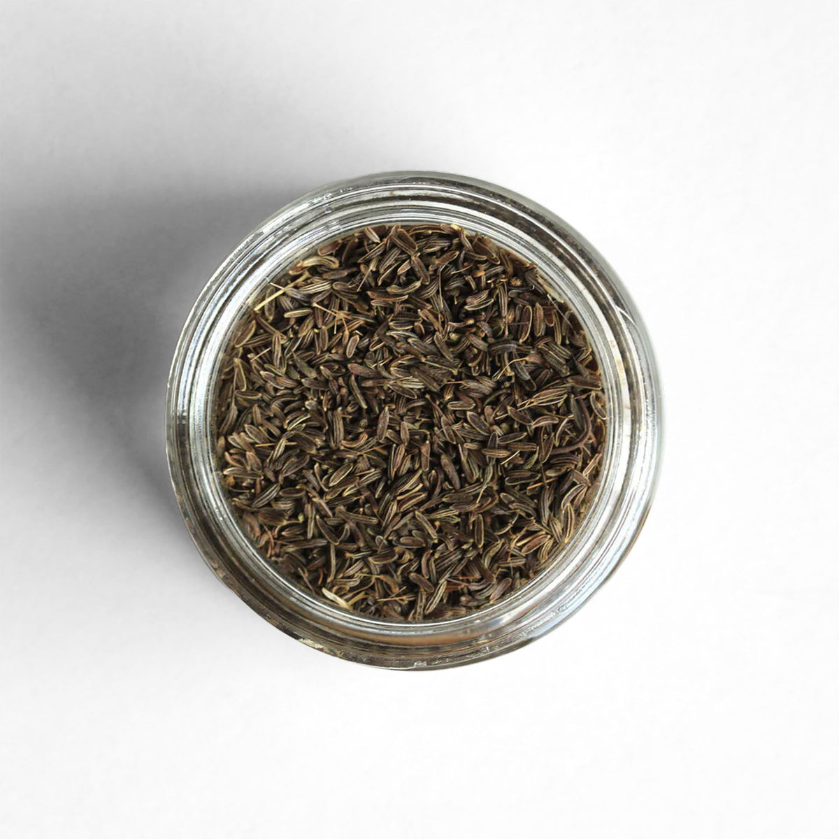 Curio Spice Co. fair-trade single origin sustainable Afghan wild cumin seed in a glass jar from above.